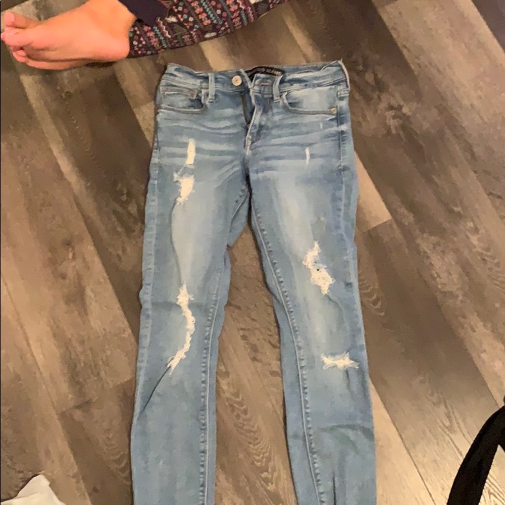 Distressed light blue jeans
